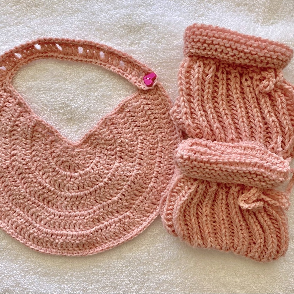 Hand crafted baby drool bib matching knit booties. Soft pink crocheted